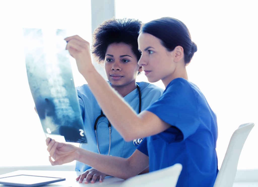 doctors with x-ray image of spine at hospital Medizinische Fachkraft